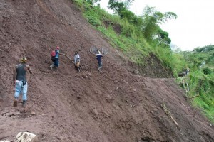 A cyclist and pedestrian make their way across one of the landslides at Cascade, Portland.  After five years of neglect, this road has began to be repaired in 2010 after it occurred in 2004. 