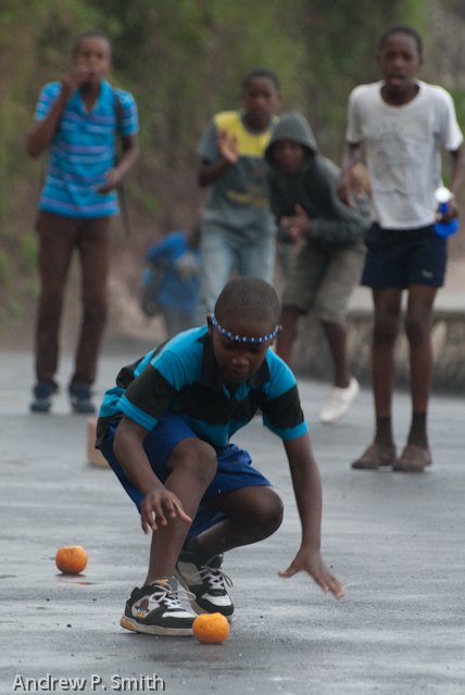 A student participates in a potato race while urged on by his team-mates during the sports day of Cascade Primary School in the Blue Mountains of Portland, Jamaica on March 27 2013. Sports day was held on a newly repaired stretch of road which had previously been destroyed by a landslide since 2004.