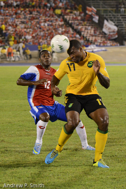 Jamaica's Westley Morgan heads the ball under pressure from Costa Rica's Joel Campbell.