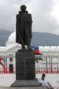 Homeless children rest at the feet of one of many statues in Port-au-Prince's historical central plaza in front of the Presidential palace on February 24, 2004.