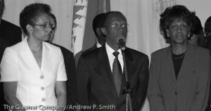 Former Haitian President Jean-Bertrand Aristide is flanked by his wife Mildred (left) and Congresswoman Maxine Waters during a press conference at the presidential palace on February 21 2004.